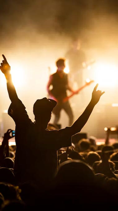 guy raising arms at a concert